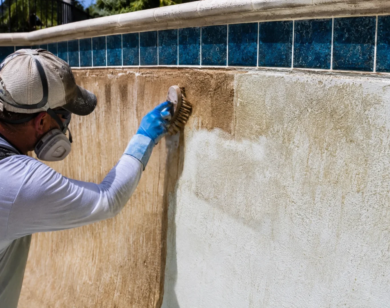 Pool specialist restoring stained plaster surface with controlled acid wash technique